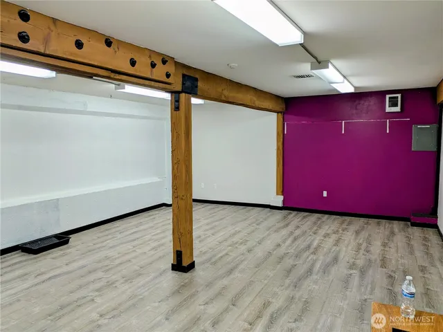 a view of a room with wooden floor