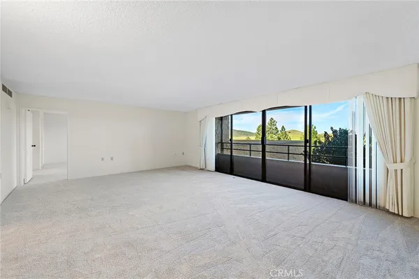 a view of an empty room with windows