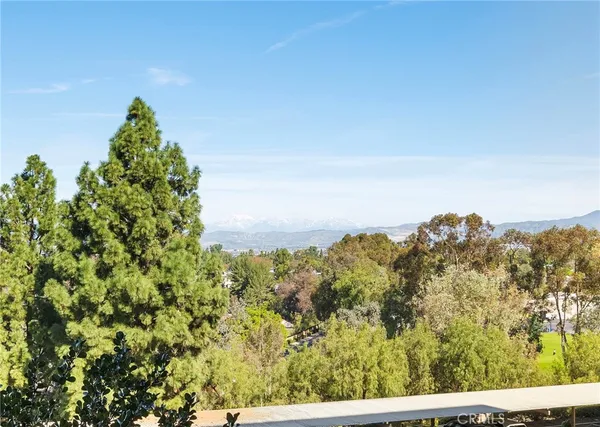 a room with wooden floor pool table and a table