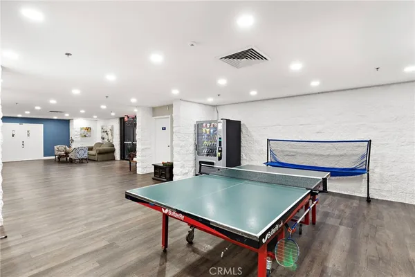 a living room with furniture a rug and gym equipment