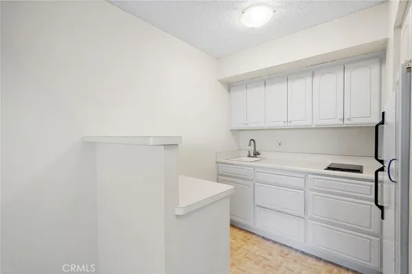 a view of a cabinets with sink and dishwasher