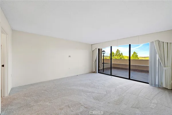 a view of an empty room with glass door