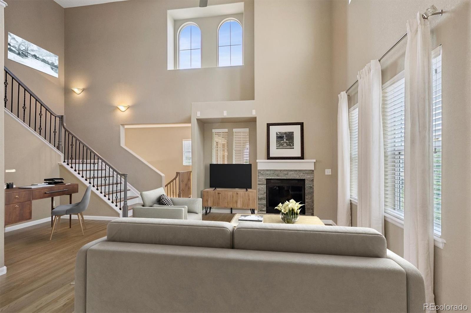 3350 Cascina Circle, Unit D Highlands Ranch, CO 80126 - Photo 1 of 40 a living room with furniture and a fireplace