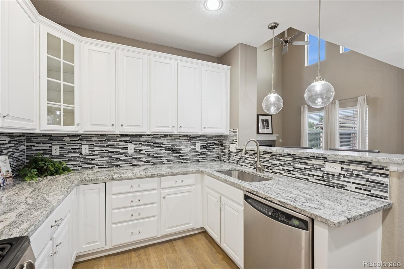 3350 Cascina Circle, Unit D Highlands Ranch, CO 80126 - Photo 13 of 40 a kitchen with granite countertop a sink and a stove