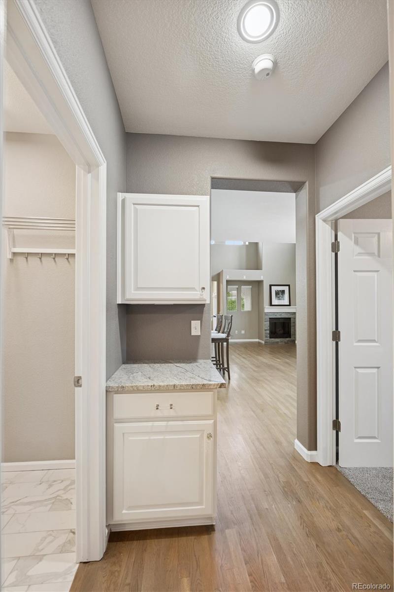3350 Cascina Circle, Unit D Highlands Ranch, CO 80126 - Photo 15 of 40 a view of kitchen and hall with wooden floor