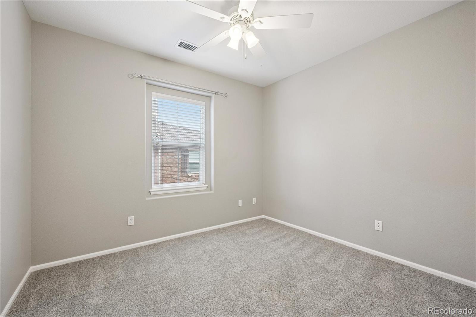 3350 Cascina Circle, Unit D Highlands Ranch, CO 80126 - Photo 16 of 40 an empty room with a window and a fan