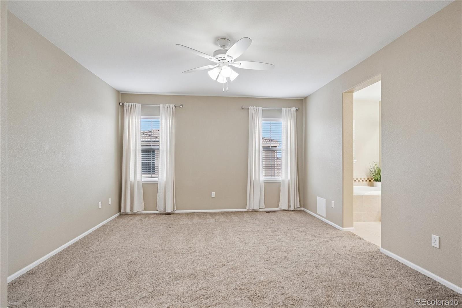 3350 Cascina Circle, Unit D Highlands Ranch, CO 80126 - Photo 20 of 40 a view of an empty room with window and chandelier fan