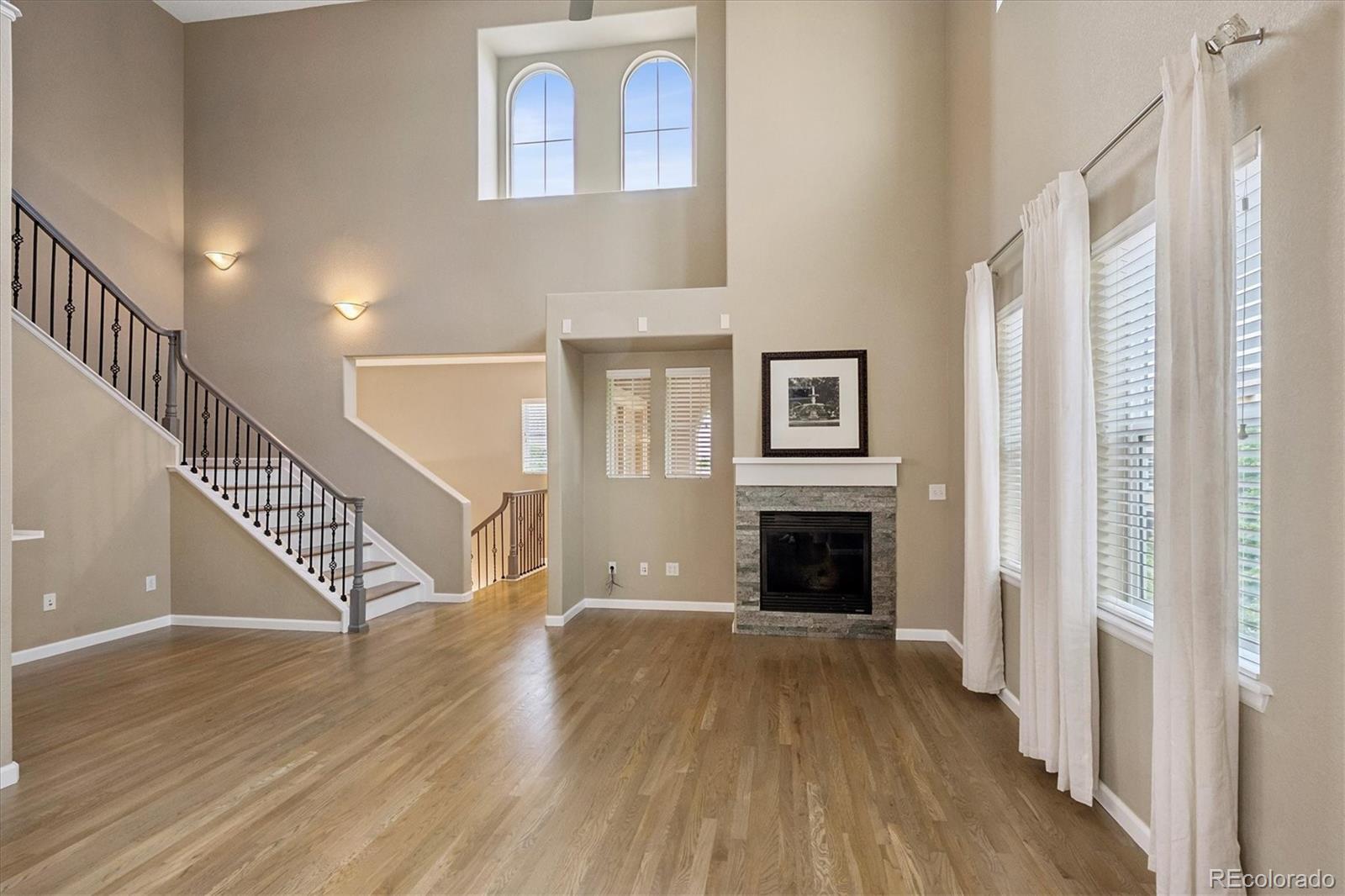 3350 Cascina Circle, Unit D Highlands Ranch, CO 80126 - Photo 2 of 40 a view of a livingroom with wooden floor and a fireplace