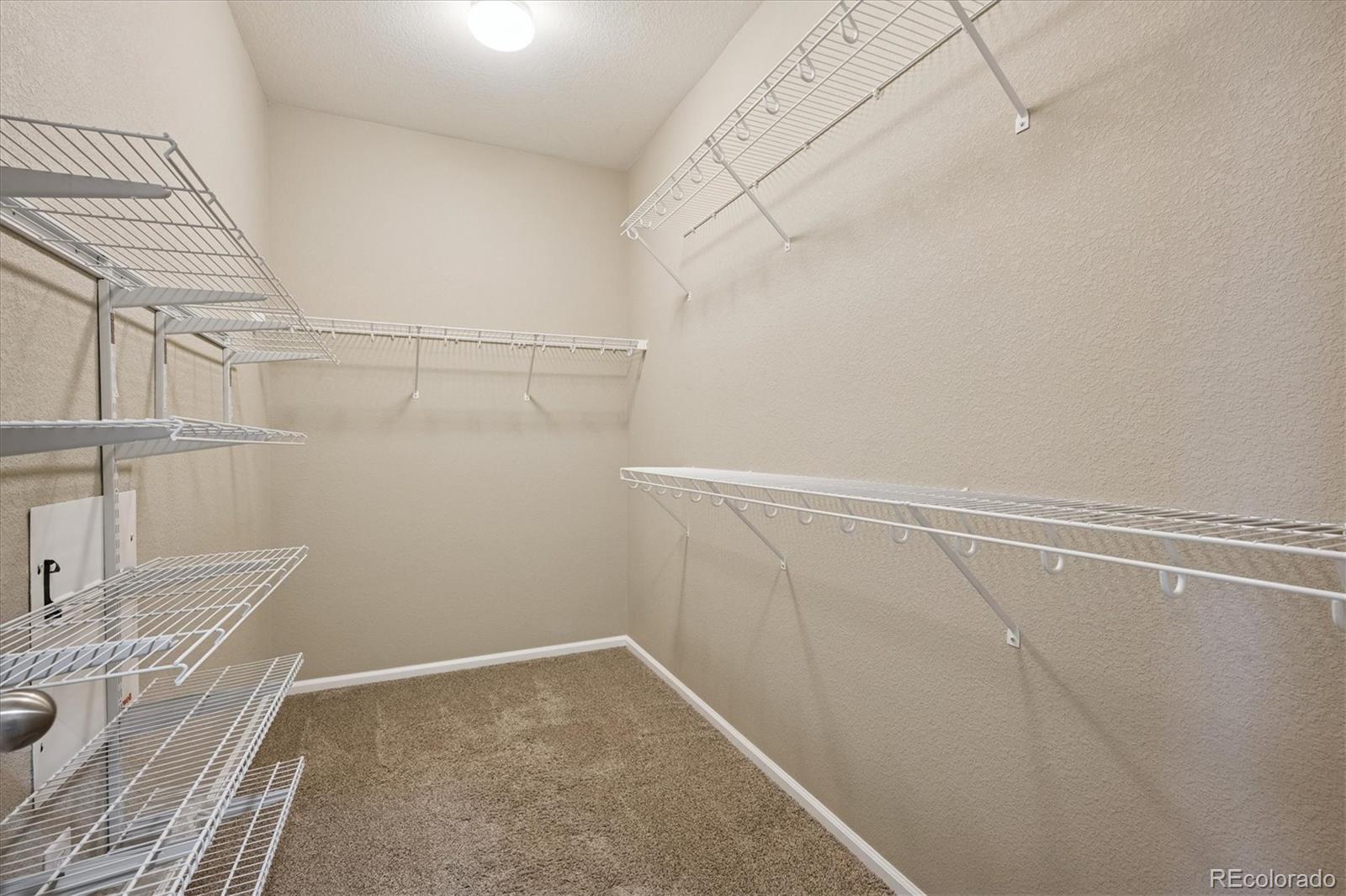 3350 Cascina Circle, Unit D Highlands Ranch, CO 80126 - Photo 24 of 40 a view of a room with racks on the wall