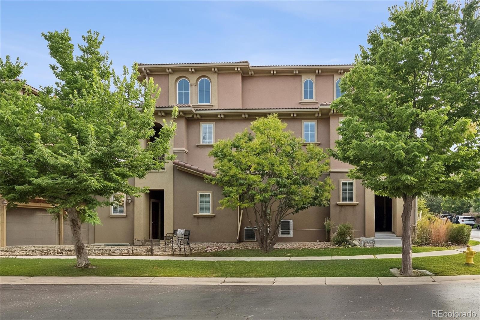 3350 Cascina Circle, Unit D Highlands Ranch, CO 80126 - Photo 4 of 40 a front view of a house with a yard and trees