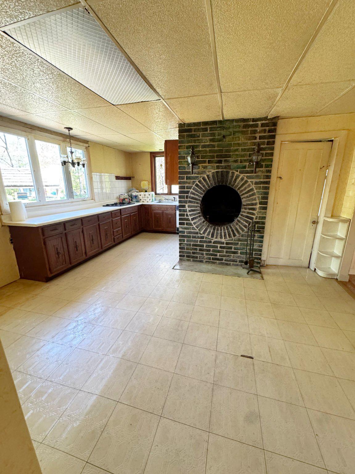 1545 Almshouse Road Jamison, PA 18929 - Photo 18 of 30 a living room with couches a fireplace and kitchen view