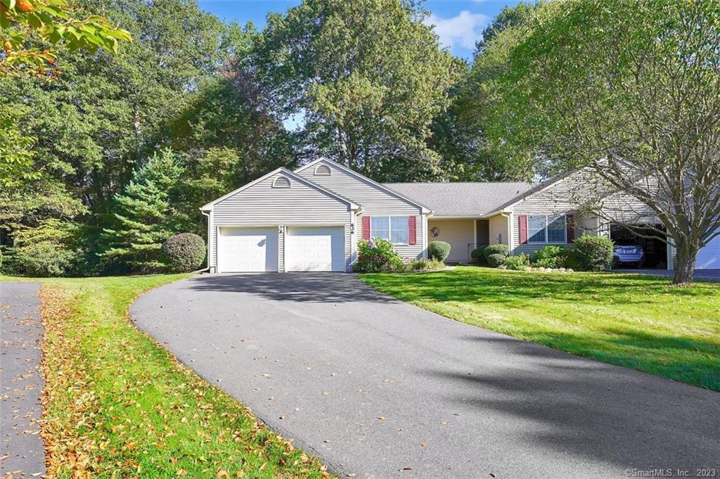 636 Locksmith Road, Unit 636 Windsor, CT 06095 - Photo 1 of 1 a front view of a house with a yard and garage