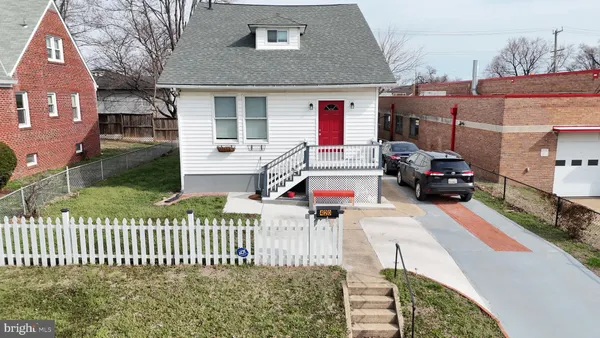 a view of a house with a small yard and sitting area