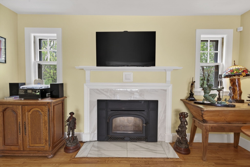 229 Parkerville Road Southborough, MA 01772 - Photo 24 of 38 a living room with furniture a fireplace and a flat screen tv