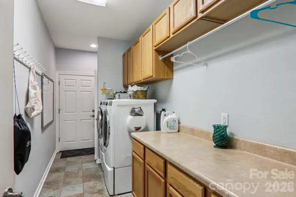 a utility room with sink dryer and washer