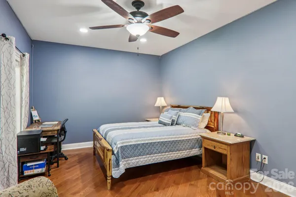 a bedroom with a bed and a desk