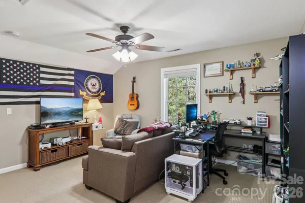 a living room with furniture a clock and a window