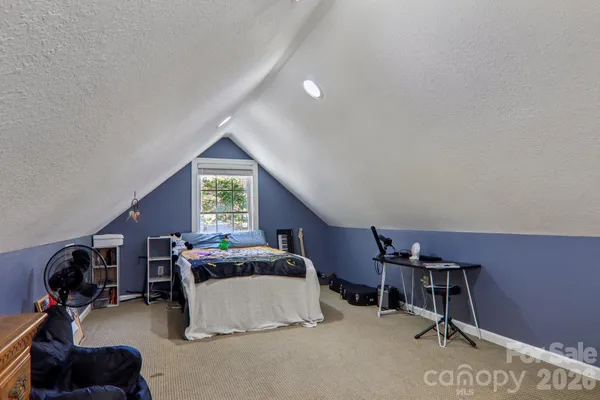 a bedroom with furniture and a window