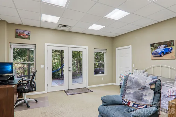 a living room with furniture gym equipment and a large window