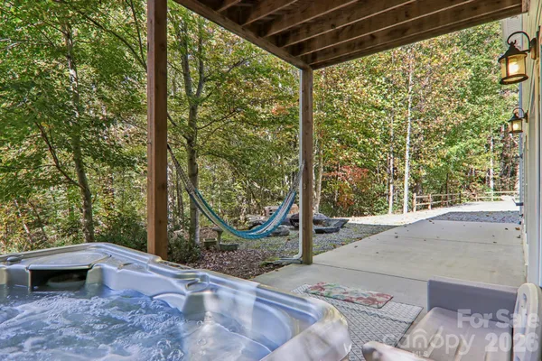 a backyard of a house with a garden and swing