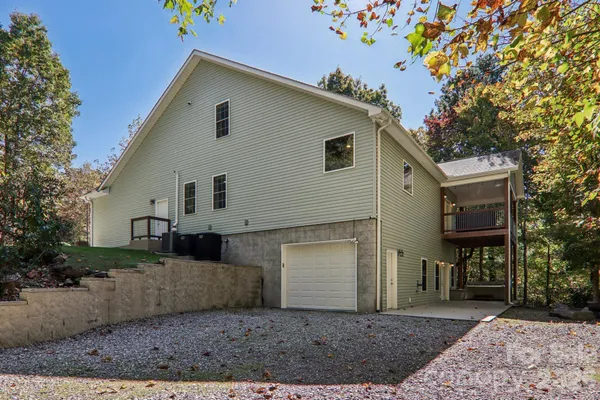 a front view of house with yard and trees in the background
