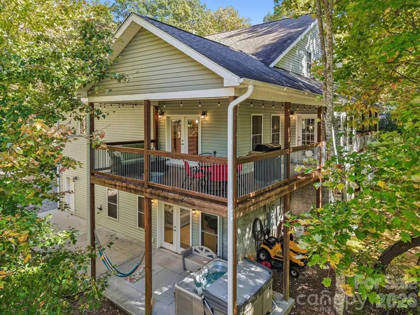 a view of a backyard with large trees and plants