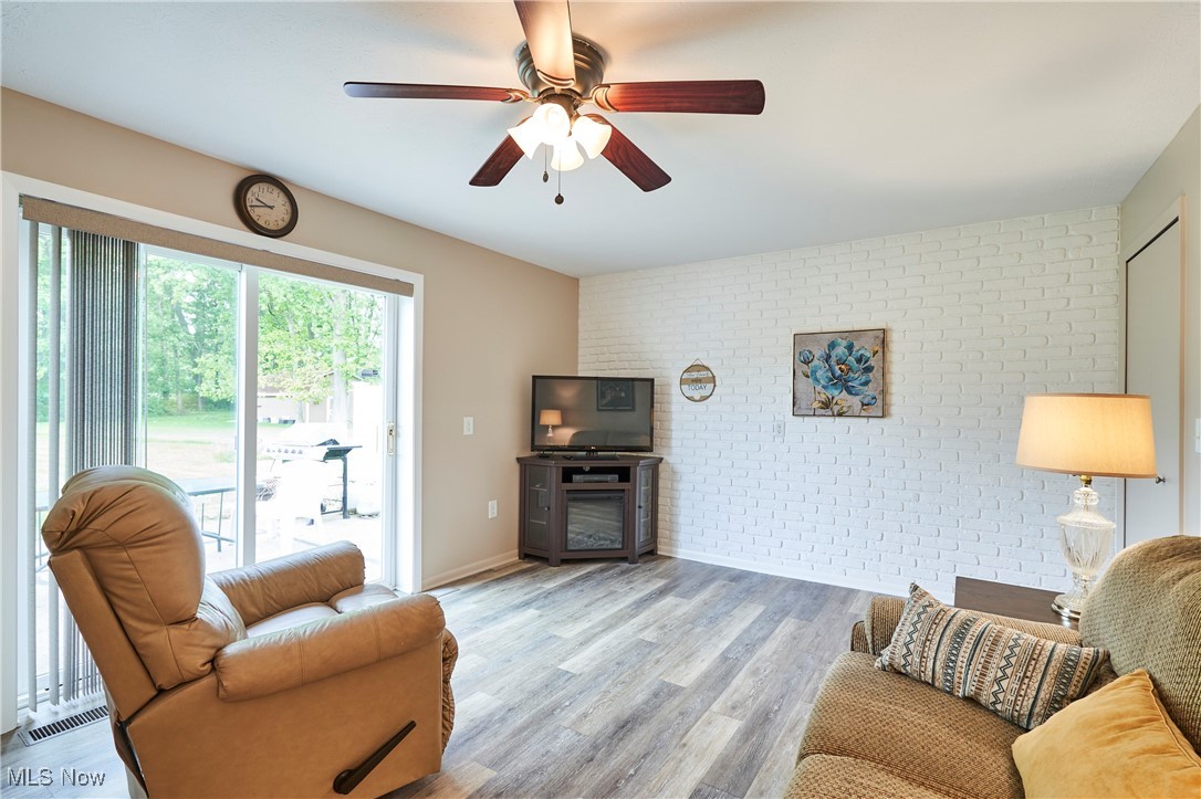 6214 Renninger Road Akron, OH 44319 - Photo 17 of 27 Family room with newer LVT flooring and slider to patio