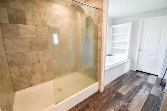 a bathroom with a bathtub and a shower