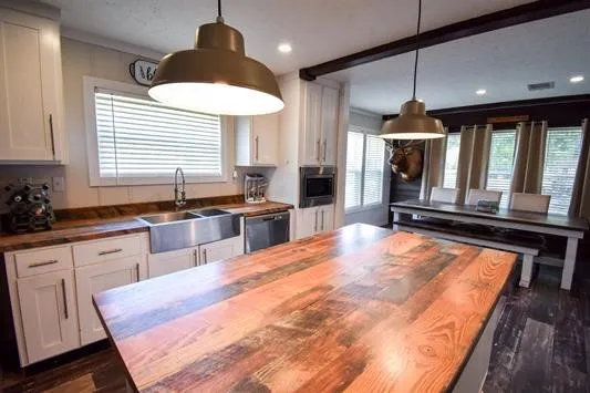 a large kitchen with granite countertop a stove and a sink