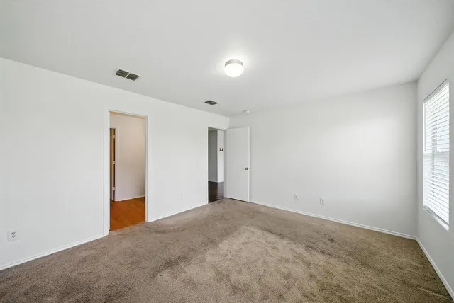an empty room with windows and closet