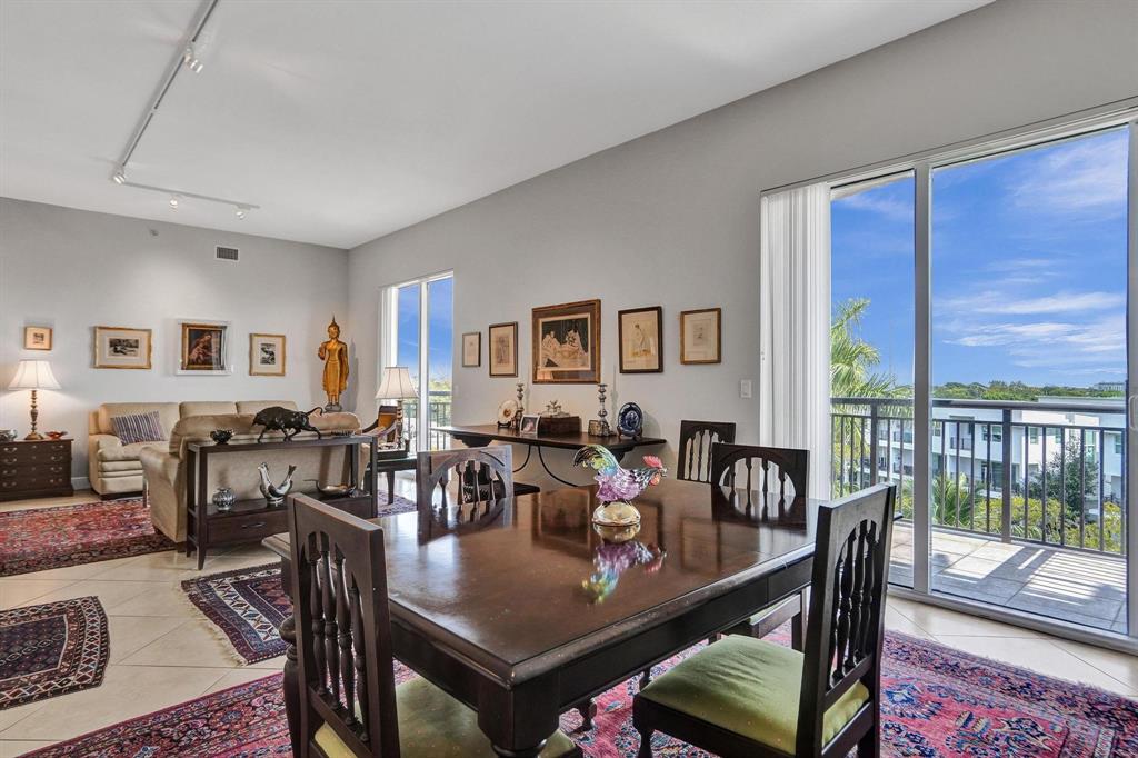 2633 Northeast 14th Avenue, Unit 400 Wilton Manors, FL 33334 - Photo 13 of 74 a view of a dining room with furniture window and wooden floor