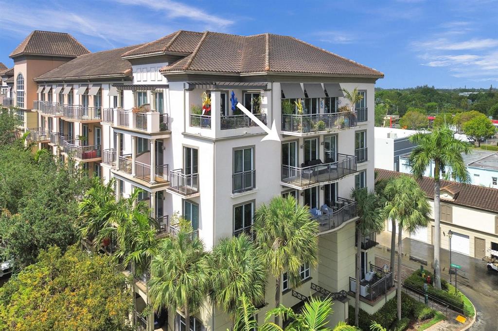 2633 Northeast 14th Avenue, Unit 400 Wilton Manors, FL 33334 - Photo 14 of 74 a front view of a building with a garden
