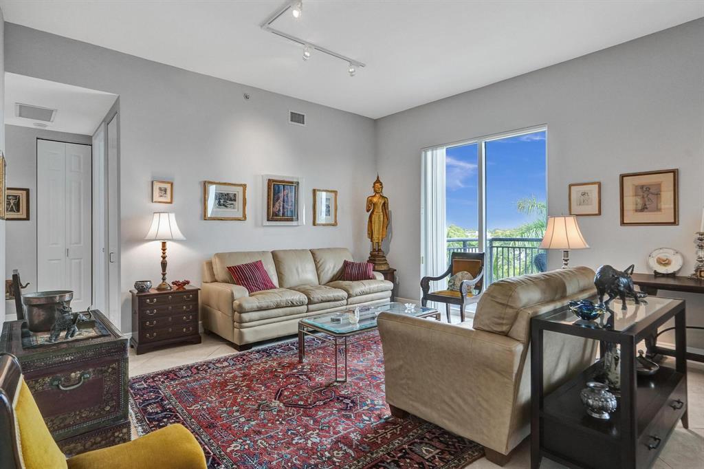 2633 Northeast 14th Avenue, Unit 400 Wilton Manors, FL 33334 - Photo 18 of 74 a living room with furniture a large window and a table