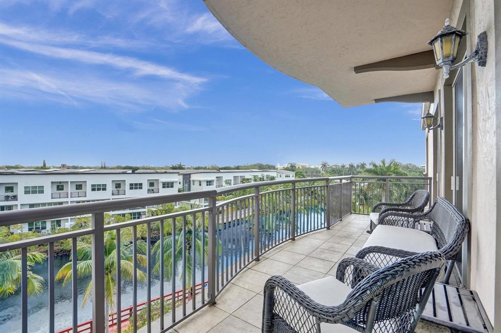 2633 Northeast 14th Avenue, Unit 400 Wilton Manors, FL 33334 - Photo 20 of 74 a view of a balcony with lake view and a floor to ceiling window