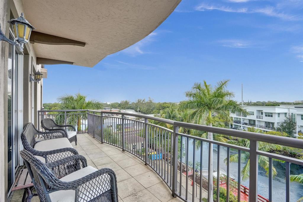 2633 Northeast 14th Avenue, Unit 400 Wilton Manors, FL 33334 - Photo 21 of 74 a view of a balcony with chairs and wooden floor