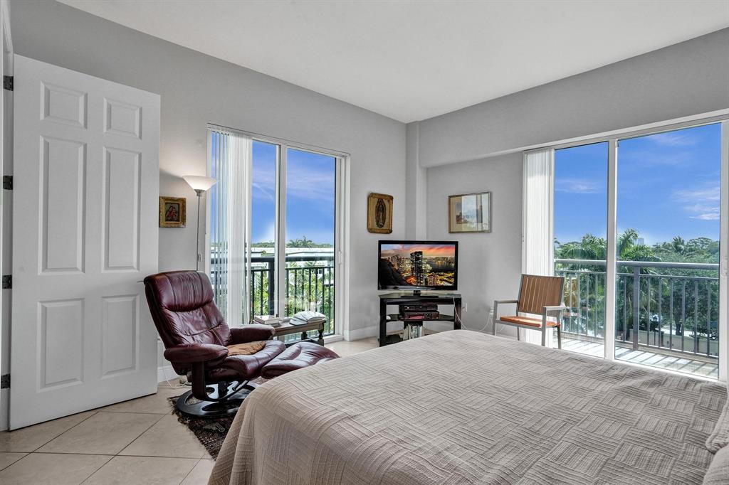 2633 Northeast 14th Avenue, Unit 400 Wilton Manors, FL 33334 - Photo 27 of 74 a living room with furniture a floor to ceiling window and chair