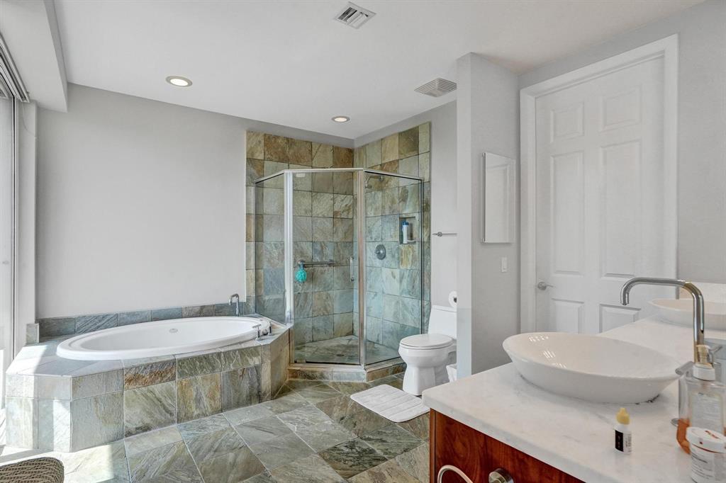 2633 Northeast 14th Avenue, Unit 400 Wilton Manors, FL 33334 - Photo 33 of 74 a bathroom with a sink toilet and shower