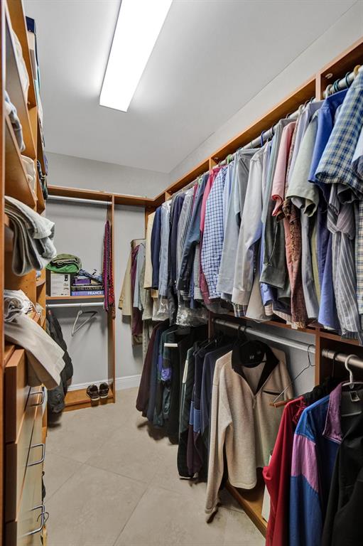 2633 Northeast 14th Avenue, Unit 400 Wilton Manors, FL 33334 - Photo 35 of 74 a view of walk in closet with clothes and shoes