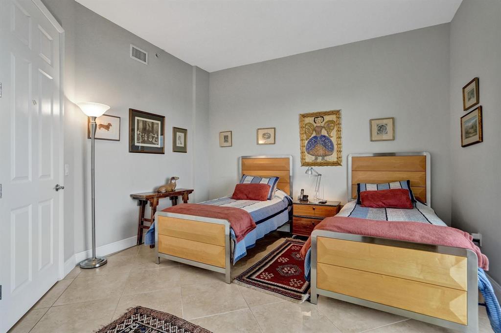 2633 Northeast 14th Avenue, Unit 400 Wilton Manors, FL 33334 - Photo 36 of 74 a bedroom with two beds and painting on the wall