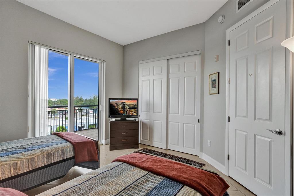 2633 Northeast 14th Avenue, Unit 400 Wilton Manors, FL 33334 - Photo 39 of 74 a bedroom with a bed and a window