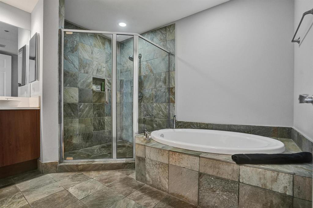 2633 Northeast 14th Avenue, Unit 400 Wilton Manors, FL 33334 - Photo 40 of 74 a bathroom with a bathtub and a shower