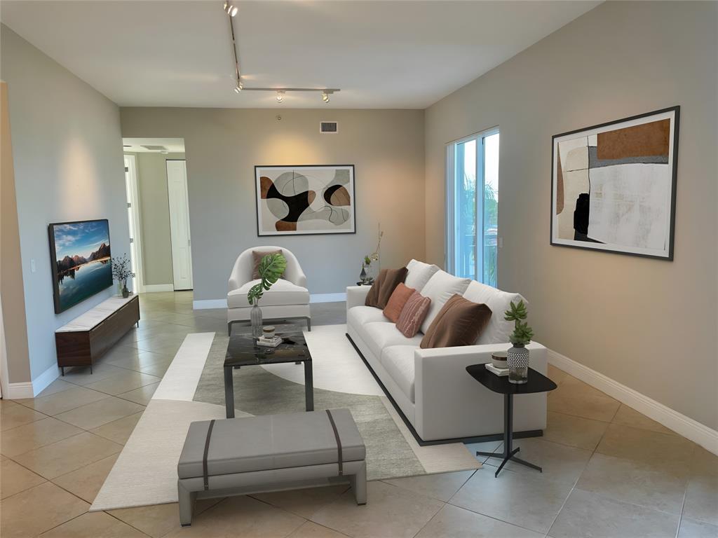 2633 Northeast 14th Avenue, Unit 400 Wilton Manors, FL 33334 - Photo 5 of 74 a living room with furniture and a mirror