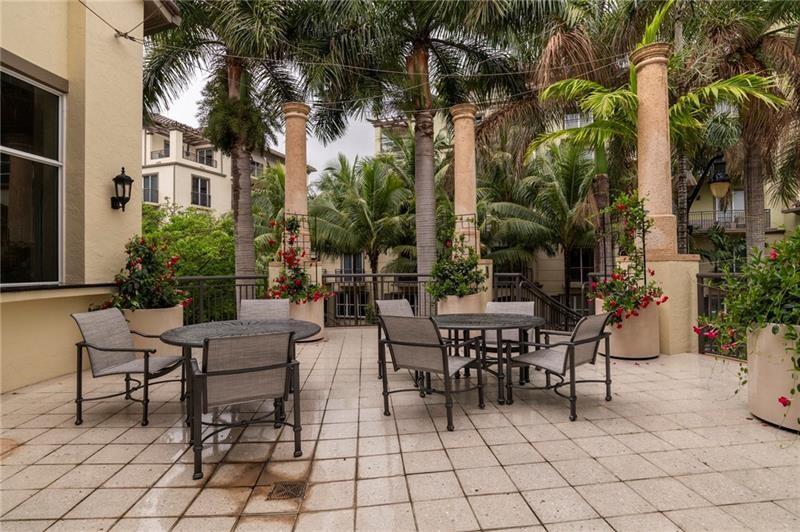 2633 Northeast 14th Avenue, Unit 400 Wilton Manors, FL 33334 - Photo 67 of 74 a view of a patio with table and chairs and potted plants
