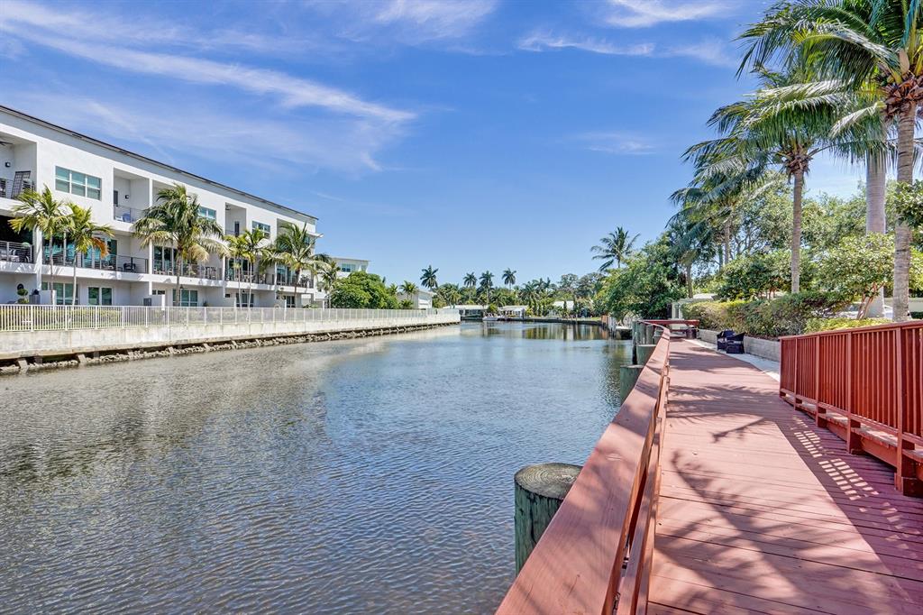 2633 Northeast 14th Avenue, Unit 400 Wilton Manors, FL 33334 - Photo 68 of 74 a view of swimming pool with outdoor seating and lake