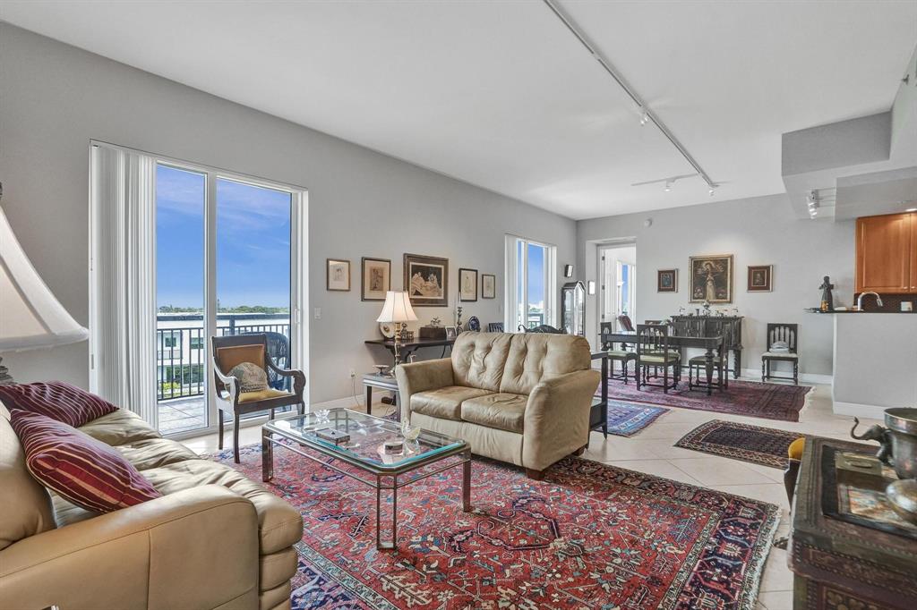2633 Northeast 14th Avenue, Unit 400 Wilton Manors, FL 33334 - Photo 8 of 74 a living room with furniture wooden floor and a table