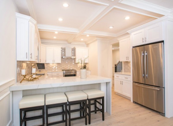 12 Suban Place, Unit 2 Newton, MA 02461 - Photo 3 of 13 a kitchen with a dining table chairs refrigerator and cabinets