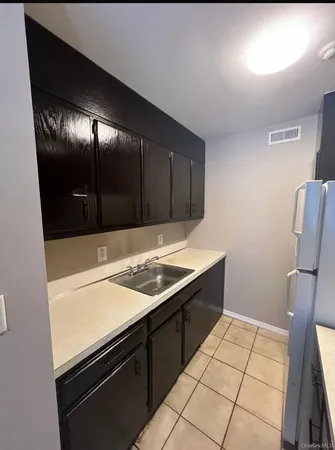 a kitchen with a sink and a refrigerator