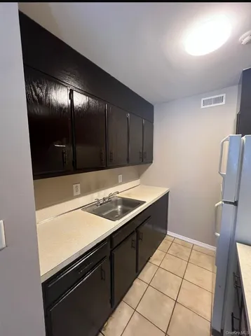 a kitchen with a sink and a refrigerator
