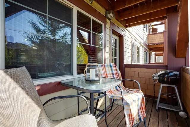 a view of a dining room with furniture a chandelier and wooden floor