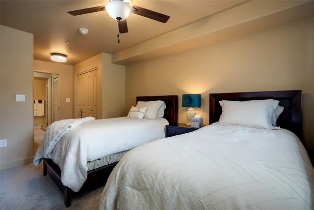 a bedroom with two beds and a chandelier